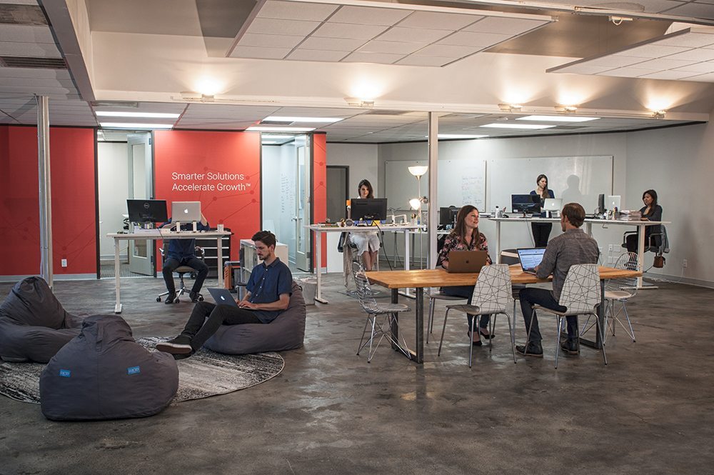 Workhorse employees sitting around tables and working collaboratively.