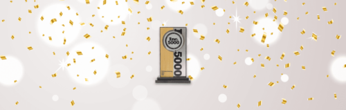 An Inc. 5000 award on a stand with golden confetti falling in the background.