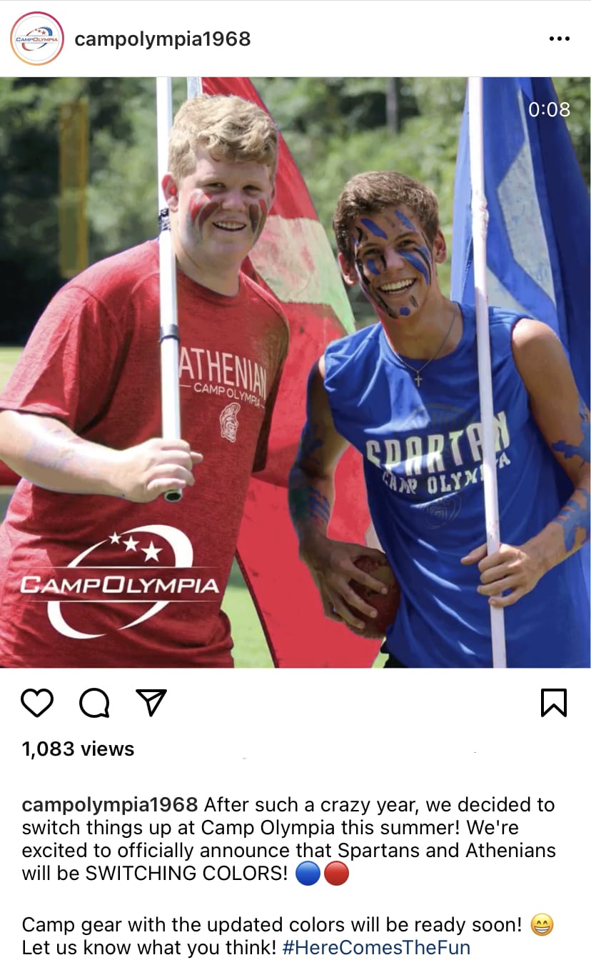 A screenshot of a Camp Olympia Instagram post with two smiling teens, one in an Athenian shirt and the other in a Spartan shirt.