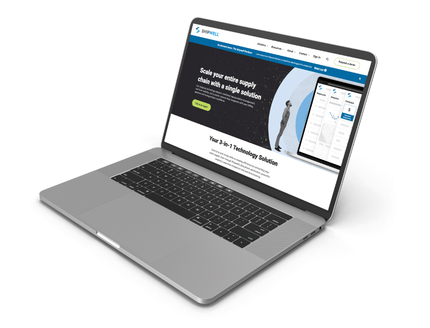 A laptop displaying the Shipwell website homepage.
